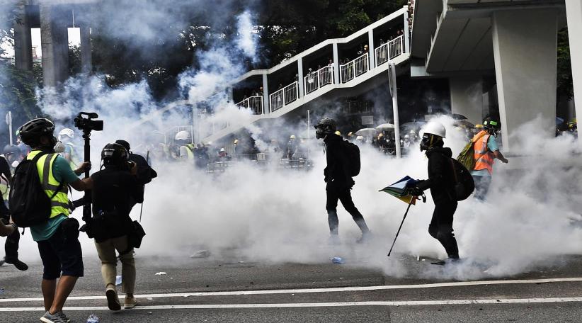 Police fire tear gas in clash with Hong Kong protesters over banned march