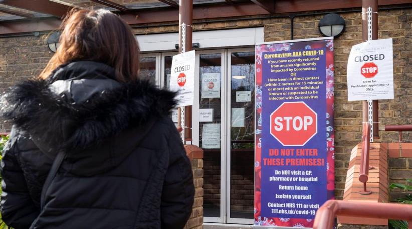 UK's Covid-19 alert level is lowered from 4 to 3