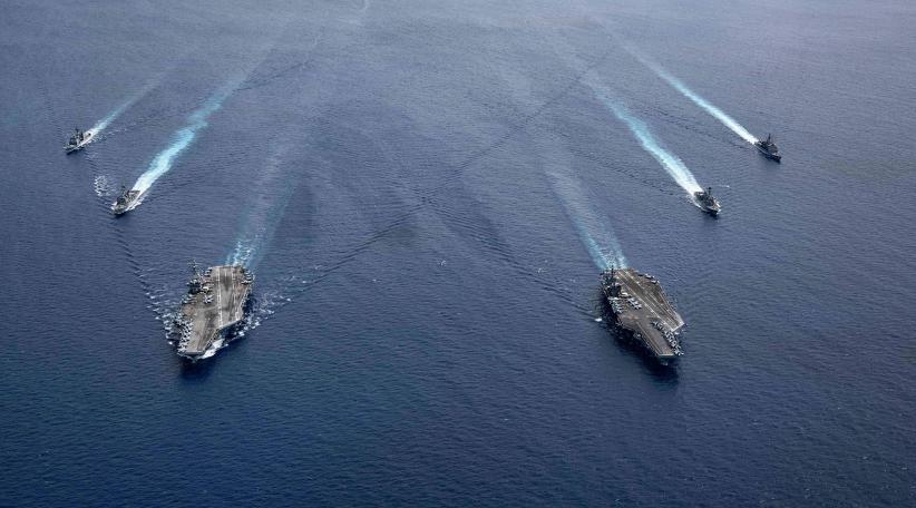 The USS Ronald Reagan (CVN 76) and USS Nimitz (CVN 68) Carrier Strike Groups steam in formation, in the South China Sea