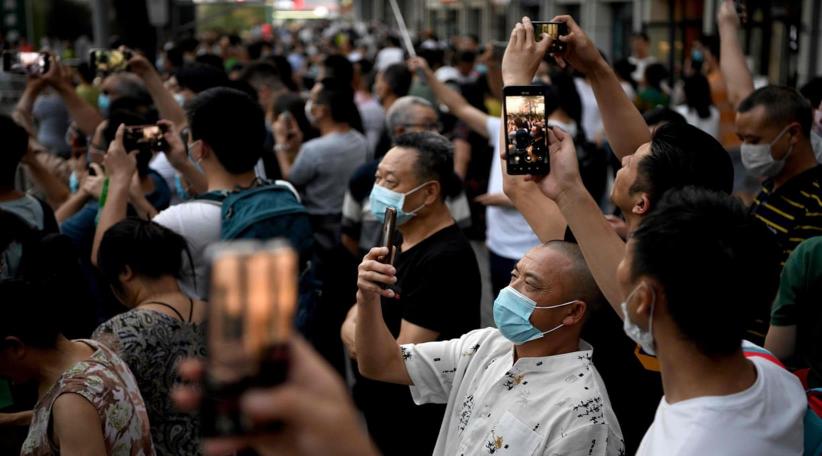Crowds wave Chinese flags and take selfies as US consulate closes in Chengdu.