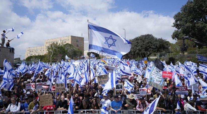 Israeli Prime Minister Benjamin Netanyahu's coalition plunged into chaos on Monday, after mass overnight protests over the sacking of his defence chief piled pressure on the government to halt its bitterly contested plans to overhaul the judiciary.