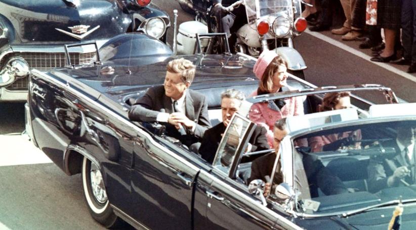 U.S. President John F. Kennedy, First Lady Jacqueline Kennedy, Texas Governor John Connally, and others smile at the crowds lining their motorcade route on November 22, 1963, in Dallas, Texas—just minutes before the President was assassinated as his car passed through Dealey Plaza.