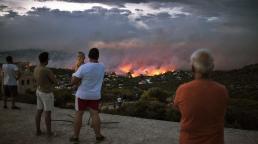 Flames ravage Greek seaside as wildfires kill 74