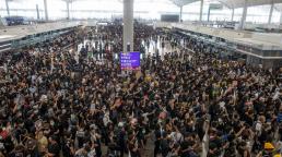Hong Kong airport grinds to a halt as protests swell