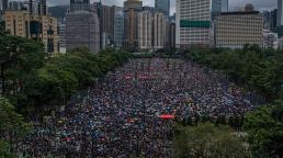 Thousands of protesters throng streets of Hong Kong as government urges calm